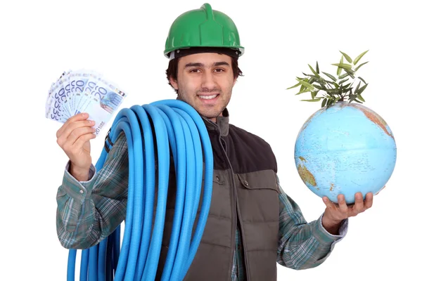 Plumber with cash and a globe — Stock Photo, Image