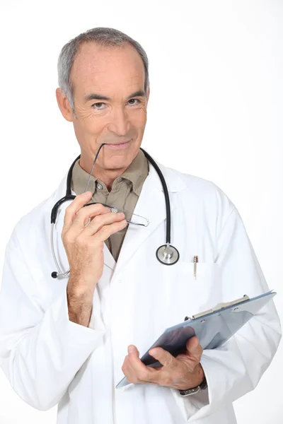 Doctor writing on a clipboard Stock Picture