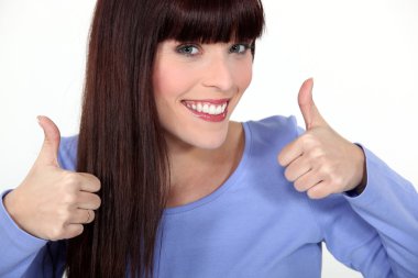 Attractive woman giving two thumbs up clipart