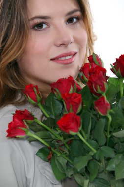 Young woman with a bunch of red roses clipart