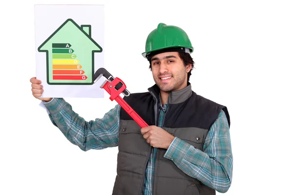 Craftsman showing the level of energy consumption of a house — Stock Photo, Image