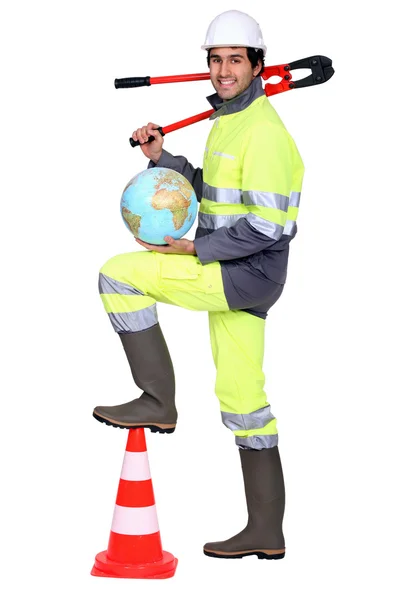 Tradesman holding a globe and a pipe wrench — Stock Photo, Image