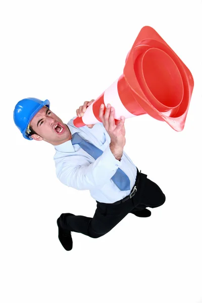 Man using a traffic cone as a loudspeaker — Stock Photo, Image