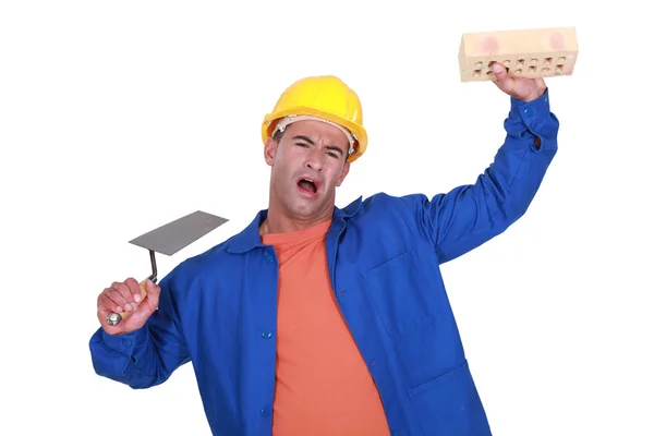Trabalhador com espátula e esponja fazendo de tolo — Fotografia de Stock