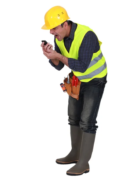 Angry builder shouting into telephone — Stock Photo, Image
