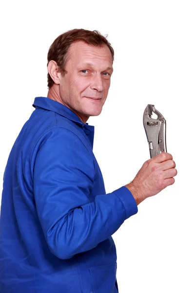 Worker holding up a tool — Stock Photo, Image