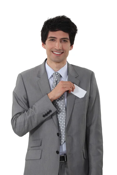 Young businessman removing business-card from pocket — Stock Photo, Image