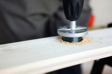 Drilling a hole in wood clipart