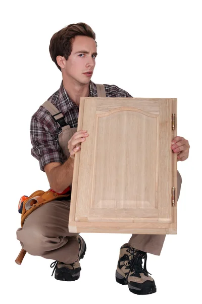 An arrogant carpenter holding up his handiwork — Stock Photo, Image