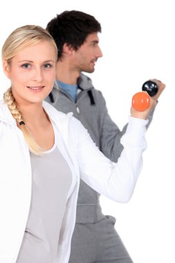 Young man and woman doing their workout clipart