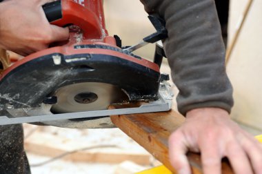 Man using a circular saw clipart