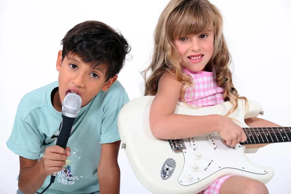 Two young children making music — Stock Photo, Image