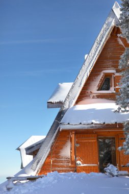 Chalet partly hidden by snow clipart