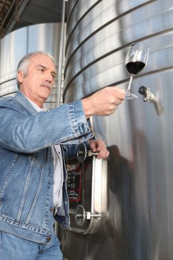 Man checking a glass of wine clipart