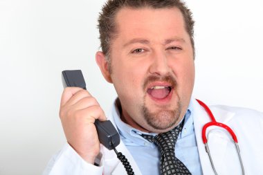 Moon-faced doctor with stethoscope arguing on phone clipart