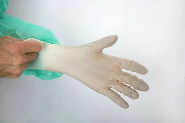 Kirurgen att sätta på en handske — Stockfoto