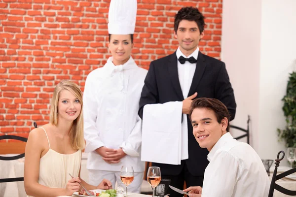 Сотрудники ресторана стояли рядом с клиентами — стоковое фото