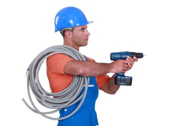 A handyman holding a drill. clipart