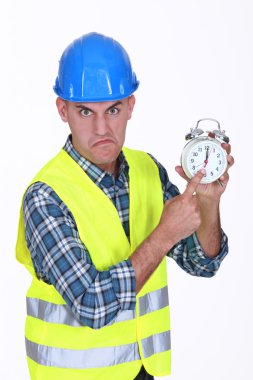 Angry builder pointing at alarm clock clipart