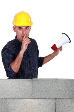 Worker with megaphone pleading silence clipart