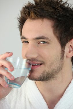 Man drinking a glass of water clipart