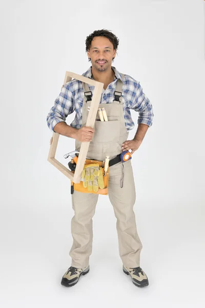 A carpenter holding a frame — Stock Photo, Image