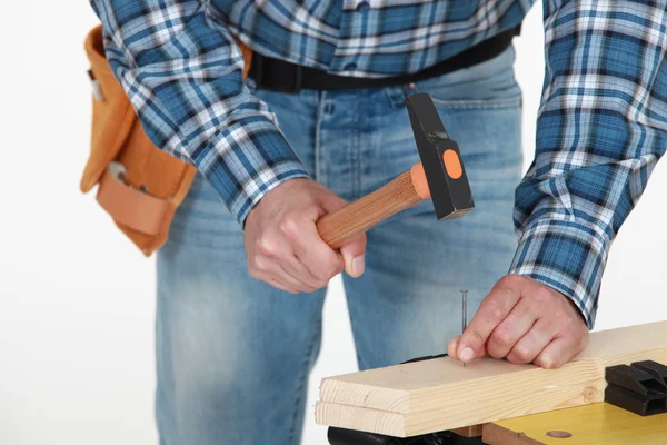 Male hands hammering nail — Stock Photo, Image