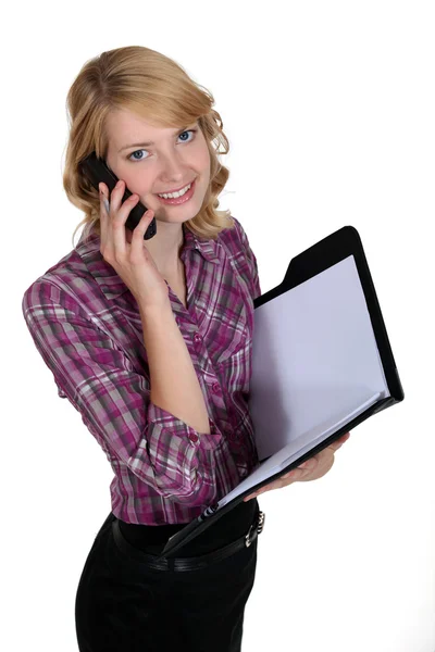 Secretary on the phone holding a folder — Stock Photo, Image