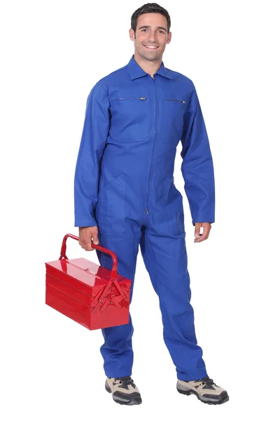 Homem vestindo macacão azul segurando kit de ferramentas — Fotografia de Stock
