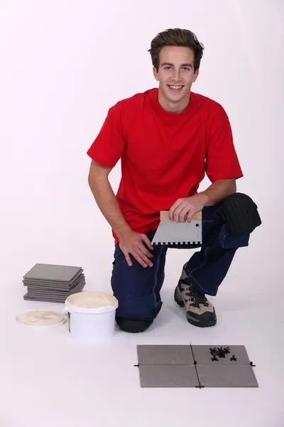 Young man laying tiles — Stock Photo, Image
