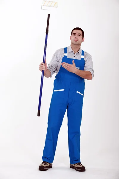 Decorator with a long paint roller — Stock Photo, Image