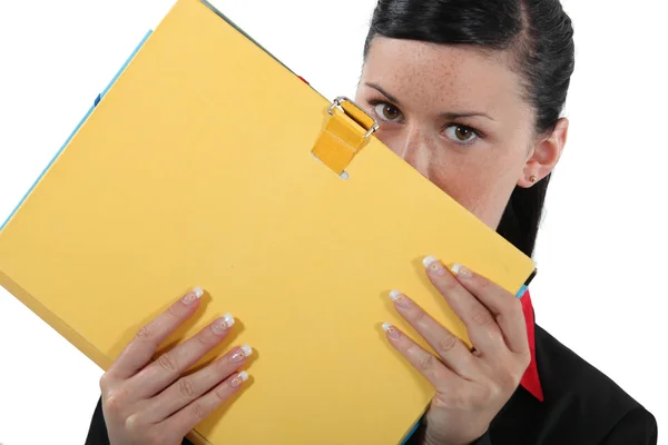 Businesswoman covering face with file — Stock Photo, Image