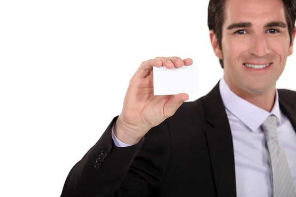Confident businessman presenting card — Stock Photo, Image