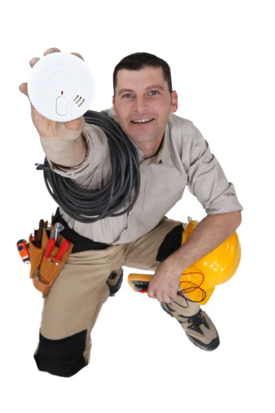 Electrician with a smoke alarm — Stock Photo, Image