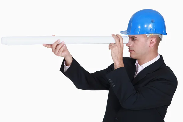 Architect looking through rolled-up plans — Stock Photo, Image