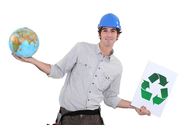 Craftsman holding a recycling label and a globe — Stock Photo, Image
