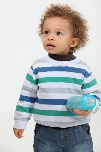 Cute toddler holding a bottle — Stock Photo, Image