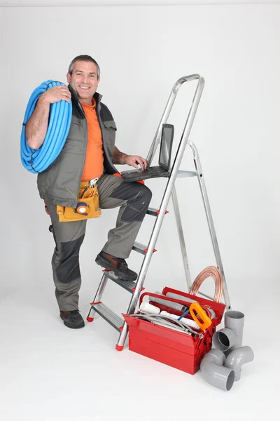 Labourer climbing step-ladder Stock Picture