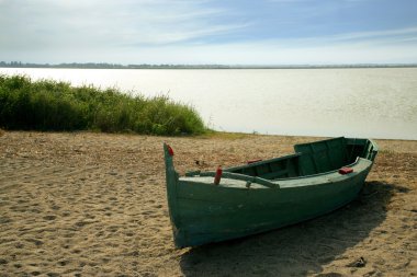 Wooden boat on a beach clipart