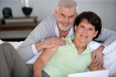 Middle-aged couple using a computer clipart