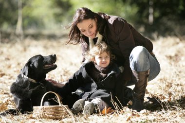 Mother and daughter with a dog clipart