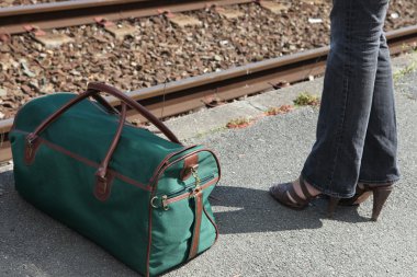 woman standing near suitcase clipart