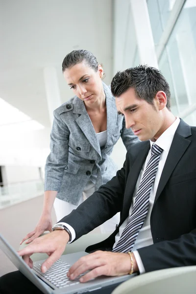 Business couple in a foyer area — Stock Photo, Image