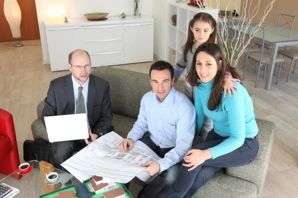 Architects giving a presentation to a young family — Stock Photo, Image