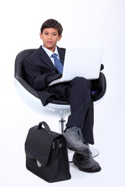 Boy playing at being a businessman clipart