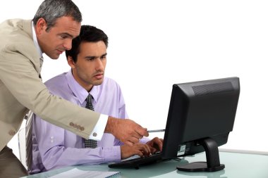 Man pointing out an error to his colleague clipart