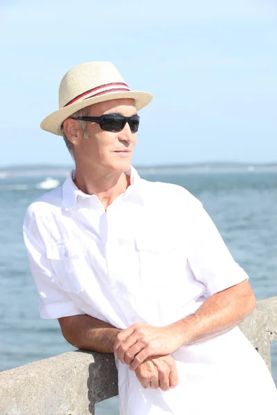 Middle-aged man on holiday stood on jetty — Stock Photo, Image
