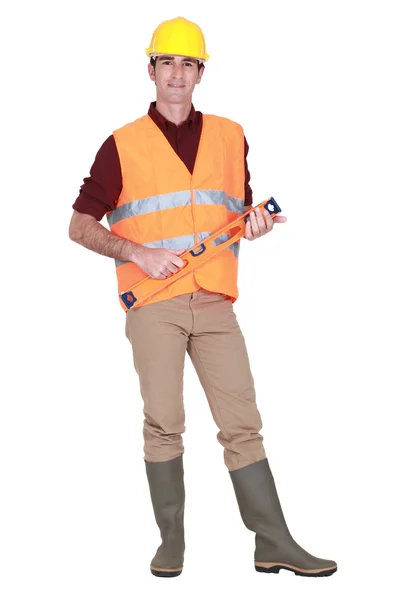 A construction worker with a level. — Stock Photo, Image