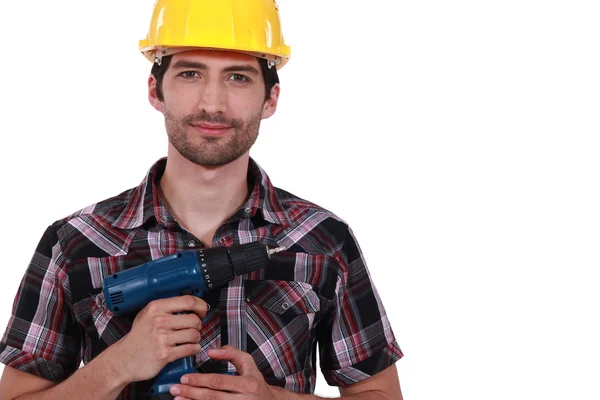 A handyman holding a drill. — Stock Photo, Image