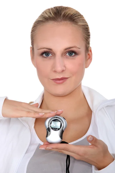 A blonde woman wearing a tracksuit and showing a mp3 reader — Stock Photo, Image